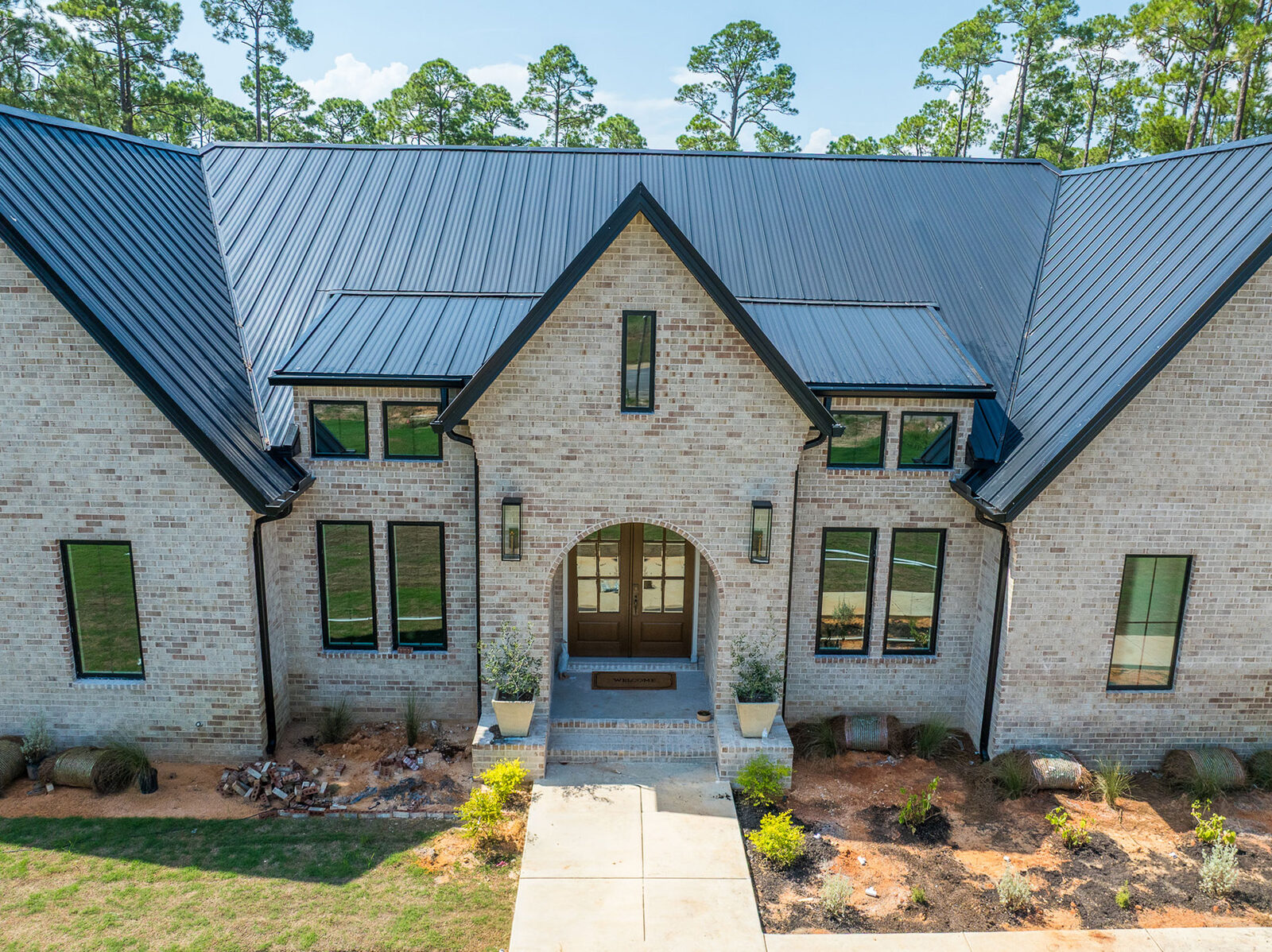 Custom luxury home with brick exterior and metal roof built by The AJAC Group in the Florida Panhandle